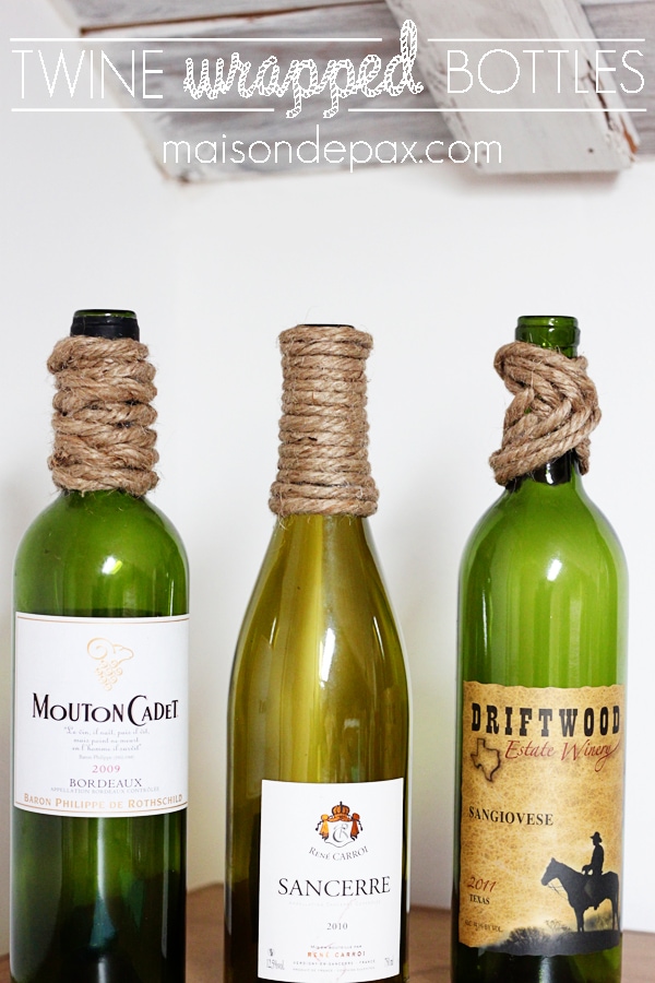 These Twine-Wrapped Bottles are inexpensive to make and the perfect easy DIY decor project! Use them as a centerpiece, vases, bookends, and more! | LoveGrowsWild.com