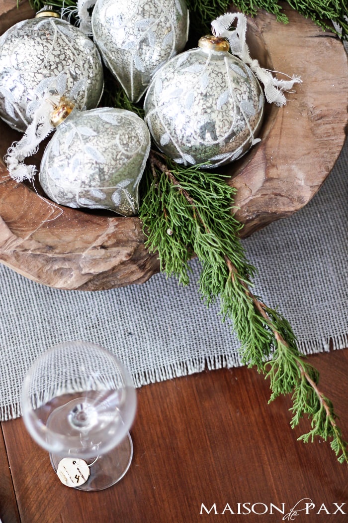 Winter table centerpiece with mercury glass ornaments and greenery in a wooden bowl | maisondepax.com