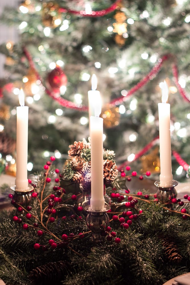 Gorgeous candle centerpiece in front of the Christmas tree