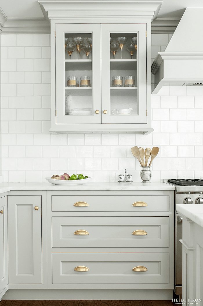 light gray cabinets with brass hardware