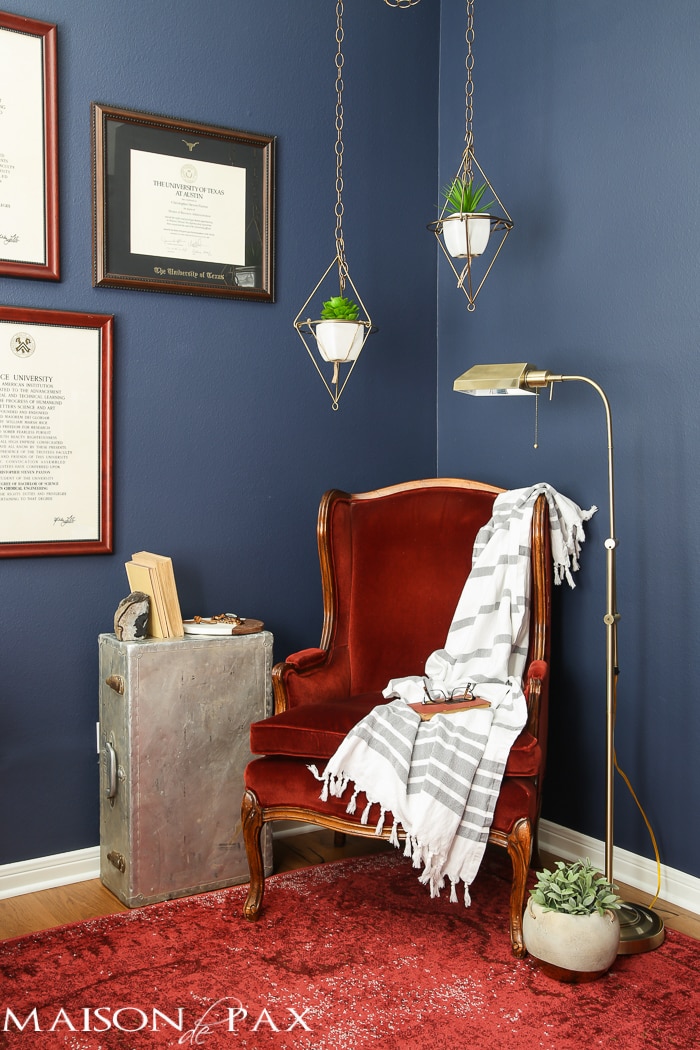Love this dark, moody, navy office with red and brass accents