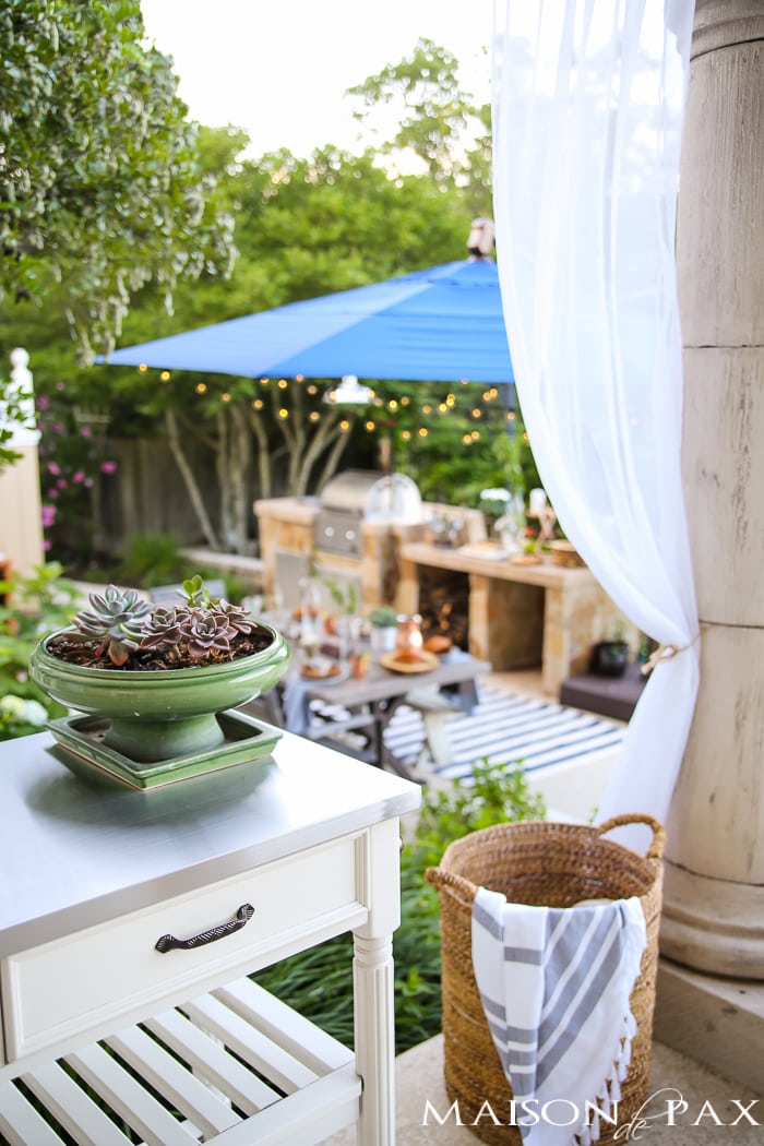 Outdoor Decorating Tips: outdoor curtains and soft twinkling lights bring instant ambiance to an outdoor dining or entertaining space