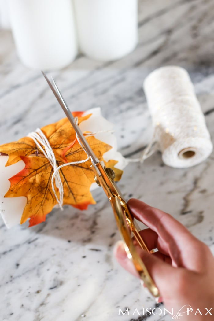 cute fall craft idea: wrap pillar candles in fall leaves and twine