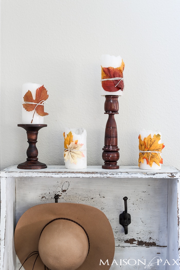 cute fall craft idea: wrap pillar candles in fall leaves and twine