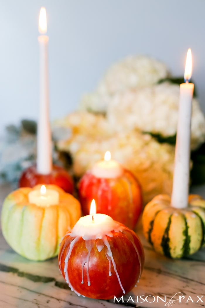 Looking for creative, easy fall decor? Learn how to make adorable mini pumpkin, gourd, and apple candles with step by step instructions and a video tutorial!