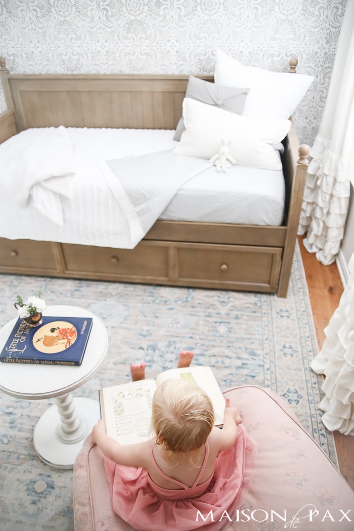 Elegant, neutral little girl room with wood tones and a stenciled accent wall: A gray-washed trundle bed provides the perfect anchor for a gorgeous, neutral yet feminine little girl's room.