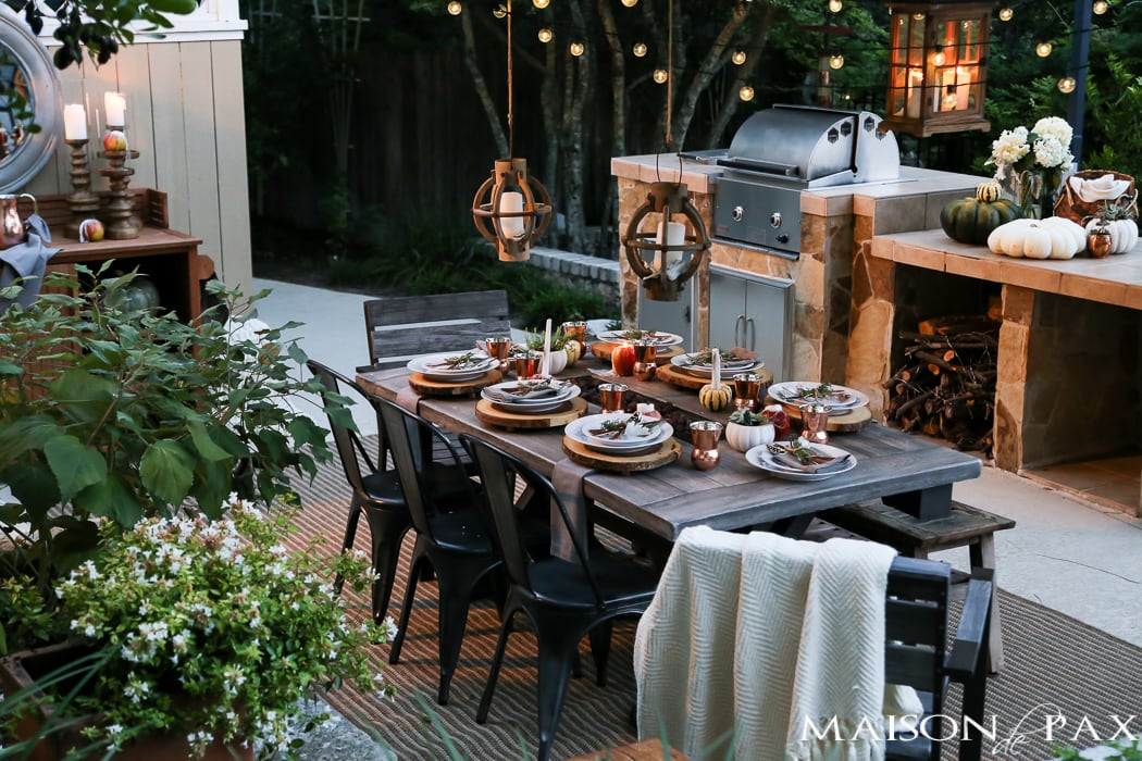 Create a rustic outdoor wedding table with candles, florals, and greenery - Maison de Pax