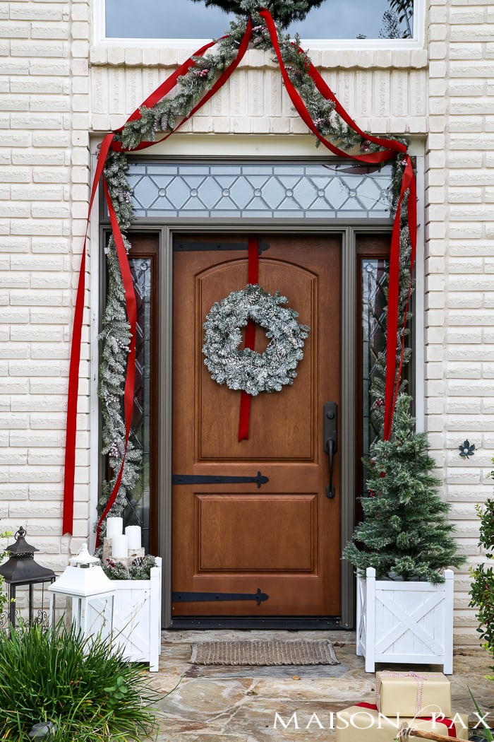 Greenery and Red Holiday Front Porch: What a beautiful, classic look! Get Christmas front porch decorating ideas here!