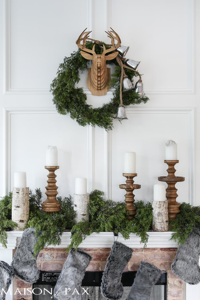 Winter Woodland Christmas Mantel: Looking for mantel decorating ideas? Some fresh cut cedar, candlesticks, and a faux deer mount creates the perfect holiday decor.