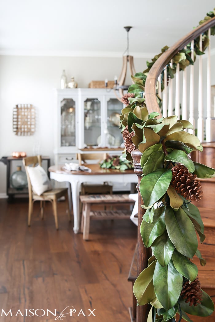 simple greenery and mercury glass makes this French farmhouse style dining room all set for Christmas!