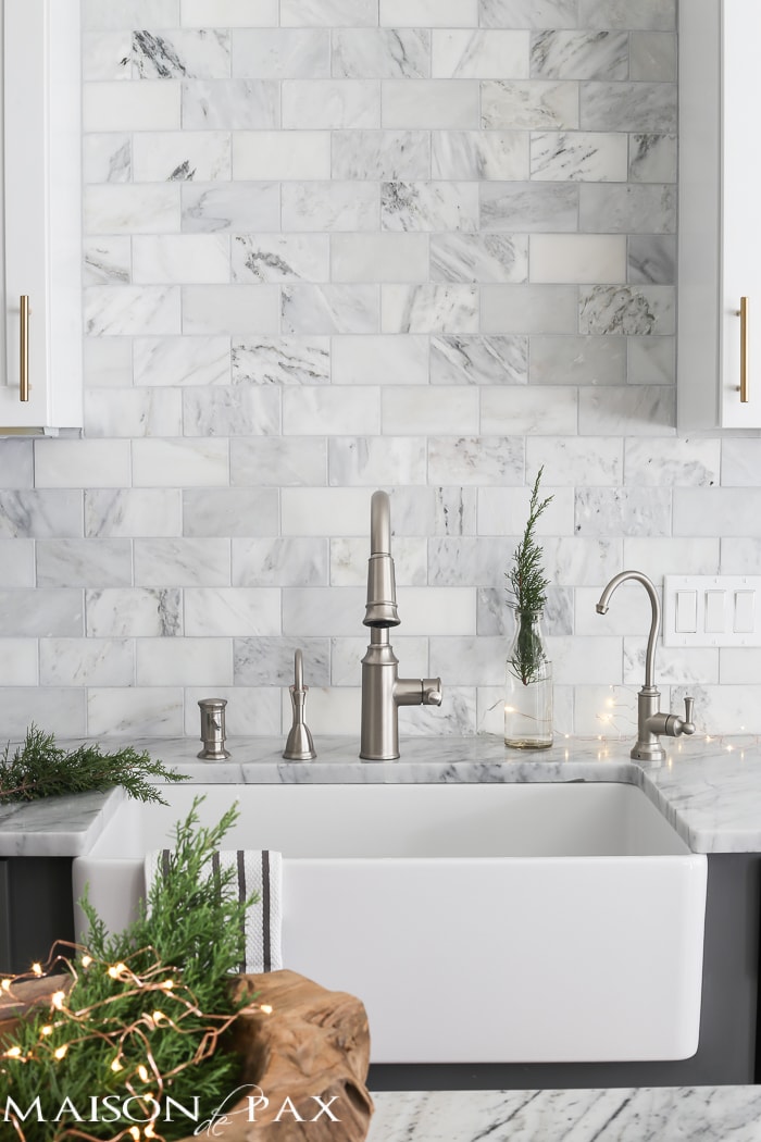 Gorgeous two-tone kitchen design with white upper cabinets, gray lower cabinets, carrara marble counters and marble subway tile backsplash - Maison de Pax