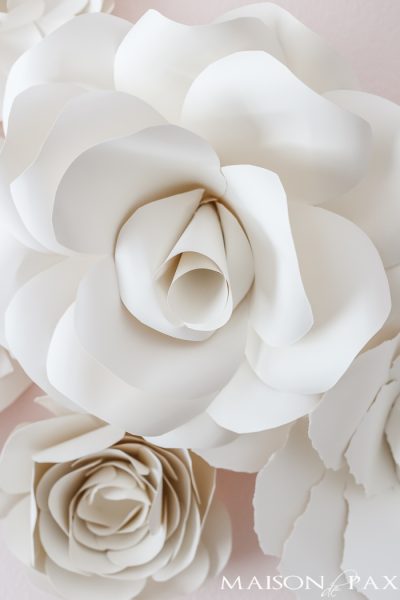 Paper Flowers as Wall Decor in a Nursery: what a gorgeous, soft, feminine space! Almost all neutral, a very pale blush on the walls and soft, natural paper flowers over the crib... Click for details on the paper flowers!
