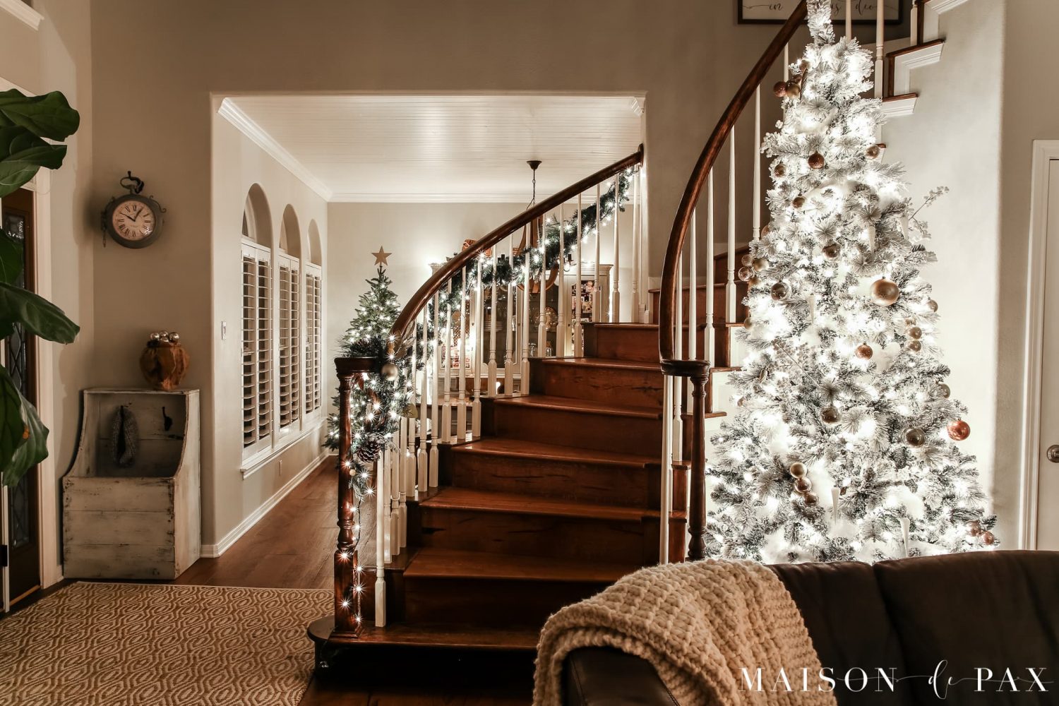 large flocked tree and small naked tree: gorgeous Christmas lights at night in these 25+ home tours #christmasnightstour #holidayhometour #christmaslights