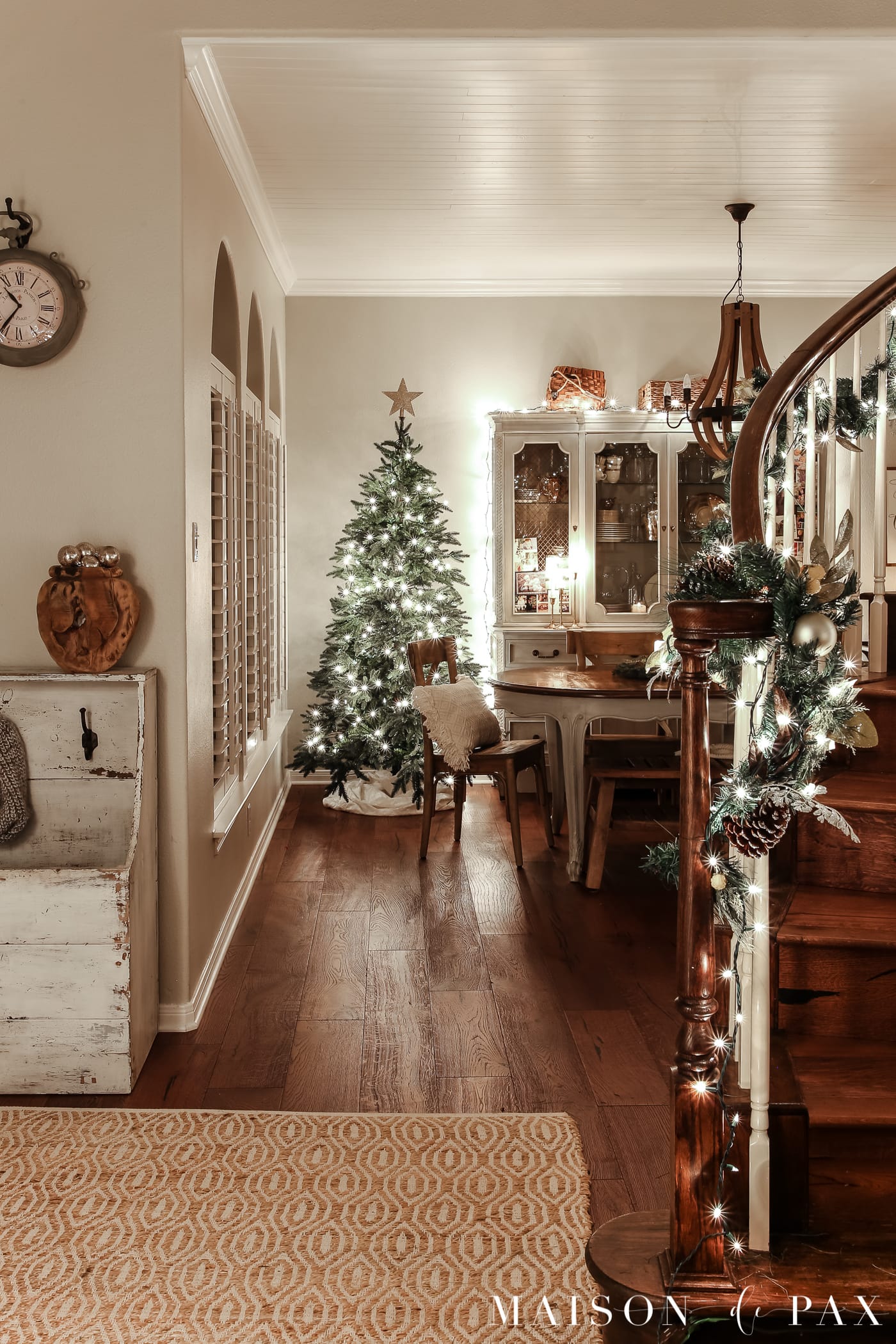 lighted stair garland and naked tree: gorgeous Christmas lights at night in these 25+ home tours #christmasnightstour #holidayhometour #christmaslights