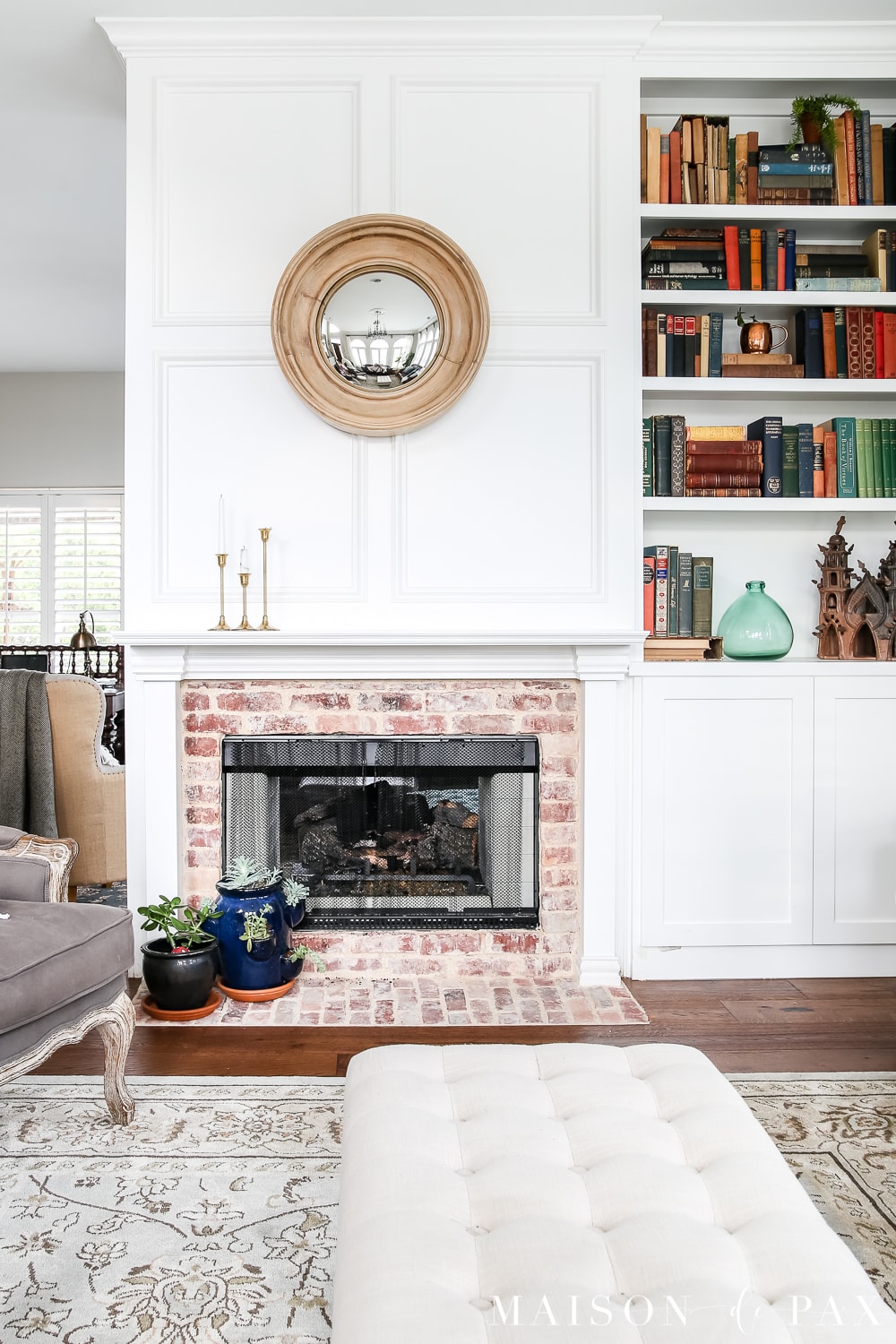White painted fireplace with built-in bookshelf and styled with modern farmhouse accessories- Maison de Pax