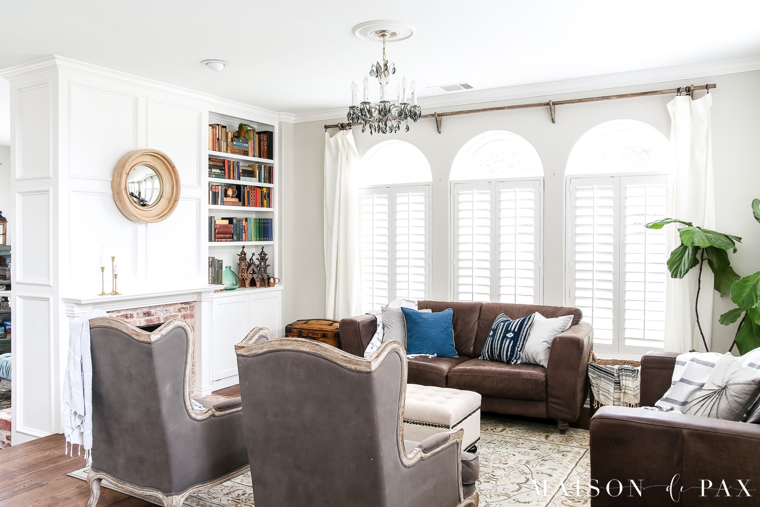 White and gray living room with pops of blue and green for spring. Wondering how to seasonally decorate your living spaces without going to too much trouble?  Get my best tips for transitioning from winter whites to neutrals, blues, and greens for a spring living room. #springdecor #springdecorating #springlivingroom #antiquebooks #howtodecorate #seasonaldecor #seasonaldecorating