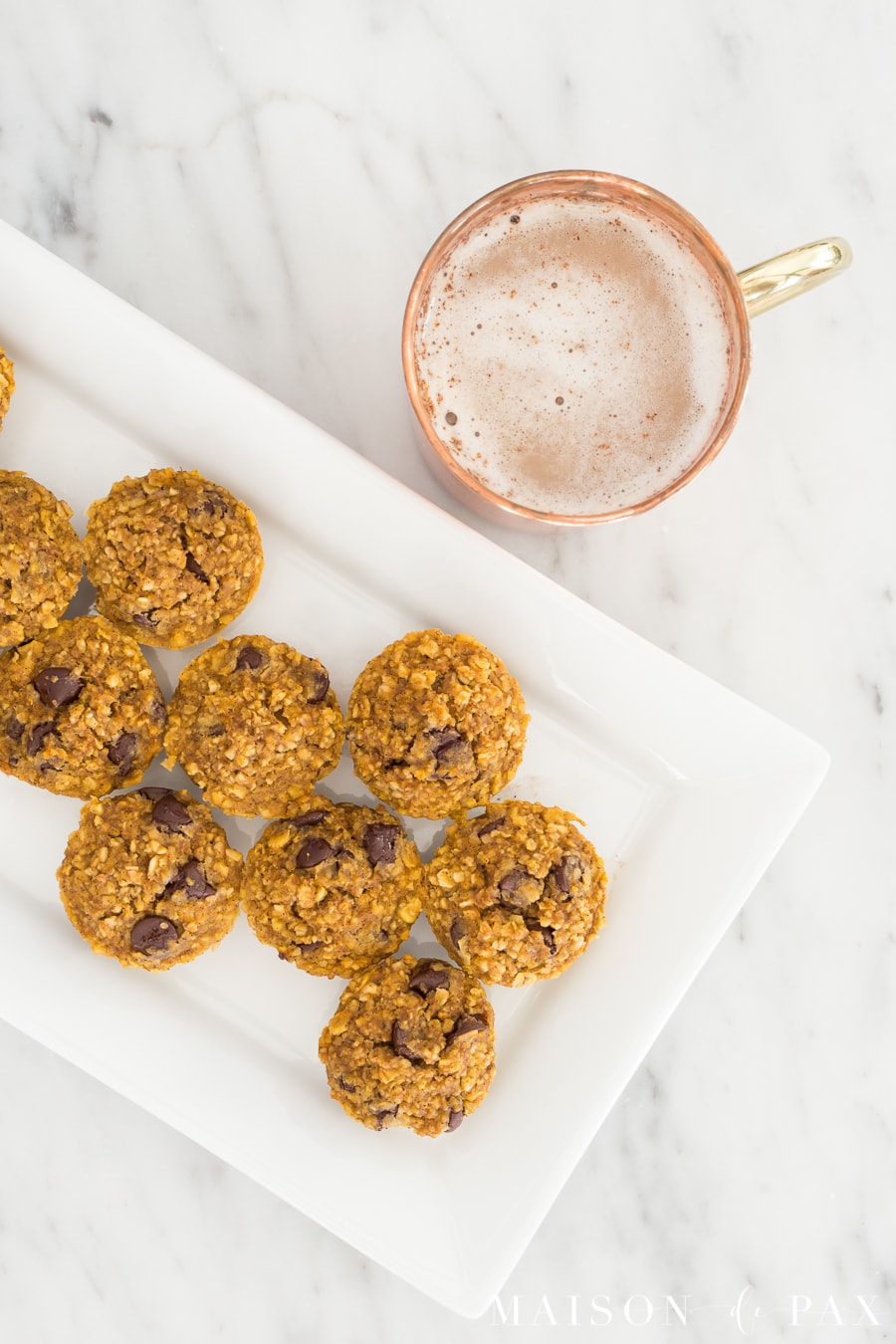 Gluten free pumpkin muffins with chocolate chips: Made with applesauce and a touch of maple syrup for sweetening, oat flour, and pumpkin, these are packed with delicious flavor and nutritious ingredients #gf #glutenfree #pumpkinspice #fallrecipe #pumpkinrecipe #pumpkinmuffins #breakfast #gfbreakfast