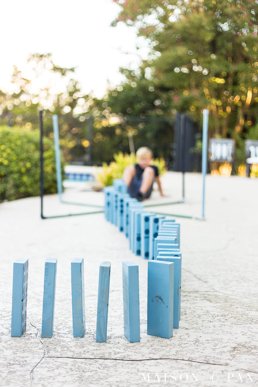 Make giant dominoes with your kids: find family projects plus tips for completing project with kids! #familyfun #familyproject #outdoorgames #kidfriendlyproject #diyproject