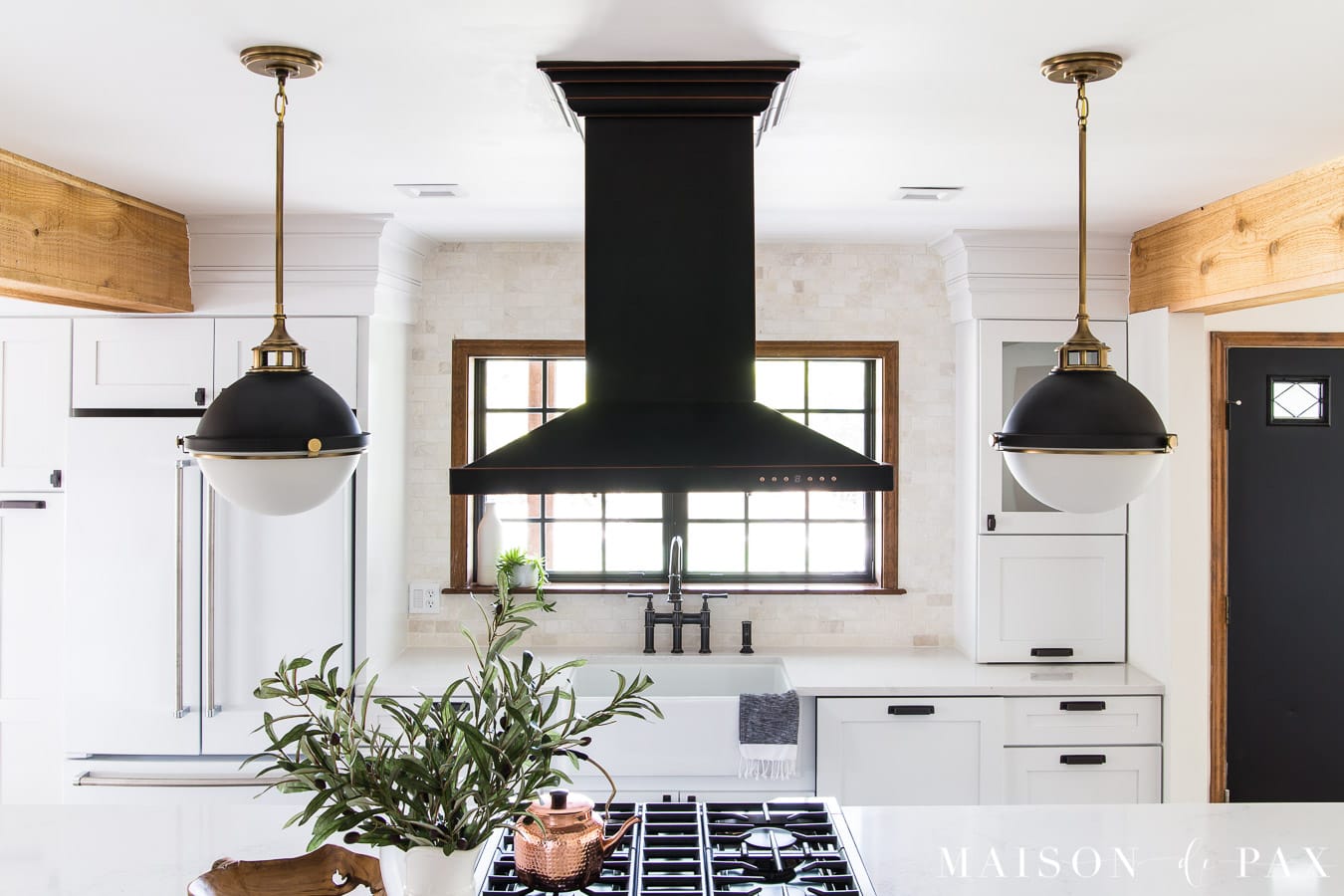 black island range hood in white kitchen | Maison de Pax