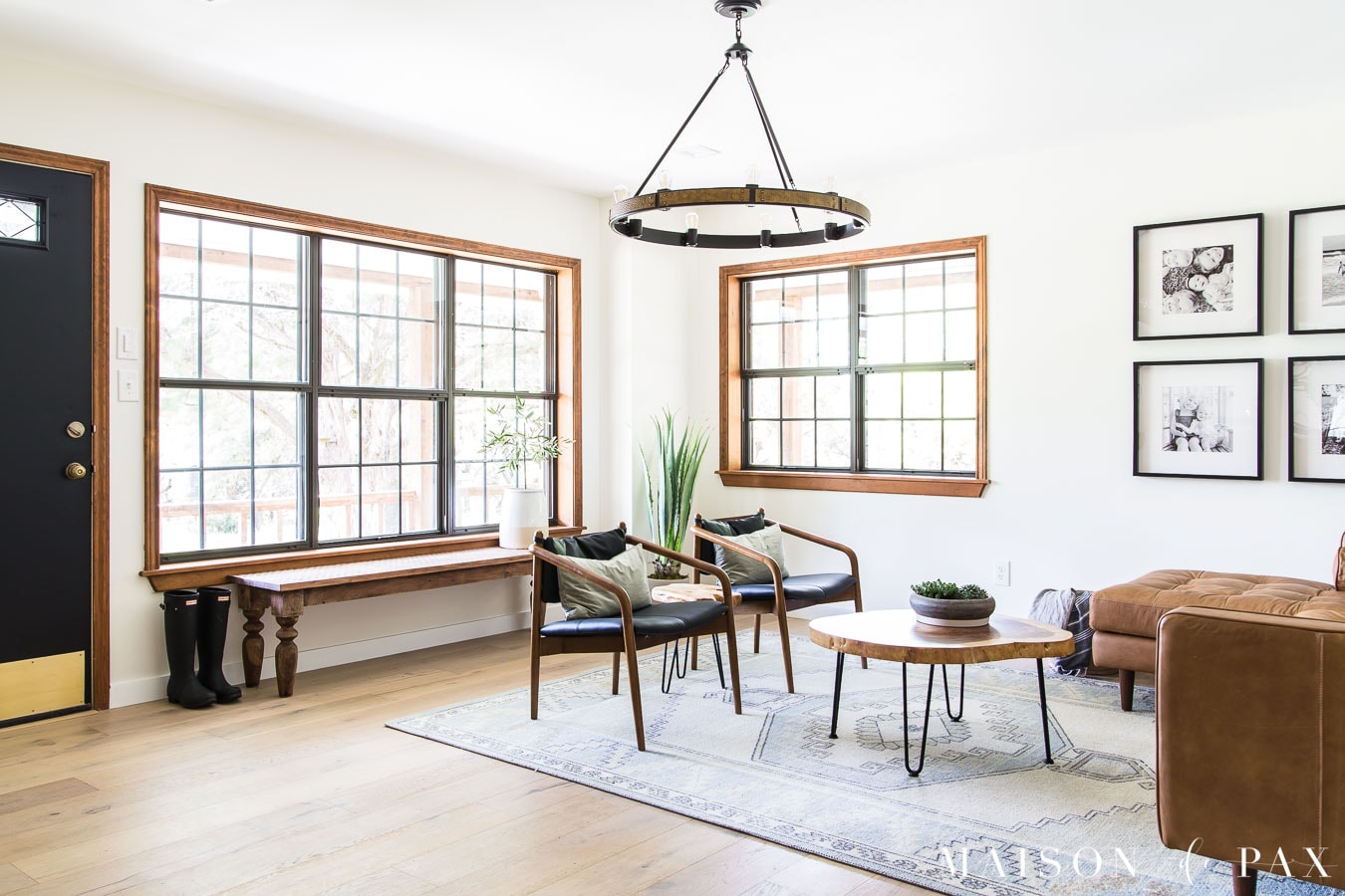 big windows with leather and wood furniture living room | Maison de Pax