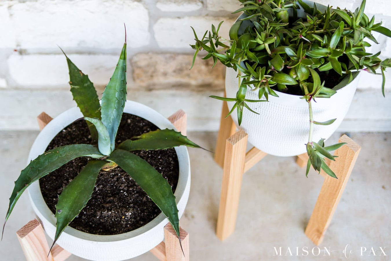 white pots in wood plant stands on porch | Maison de Pax