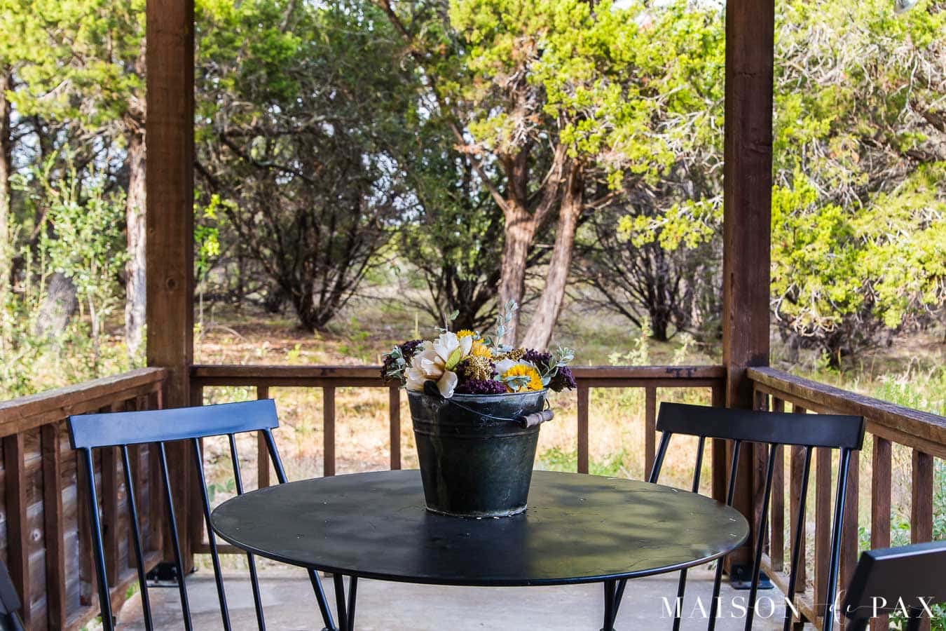 galvanized bucket with flowers on patio table | Maison de Pax