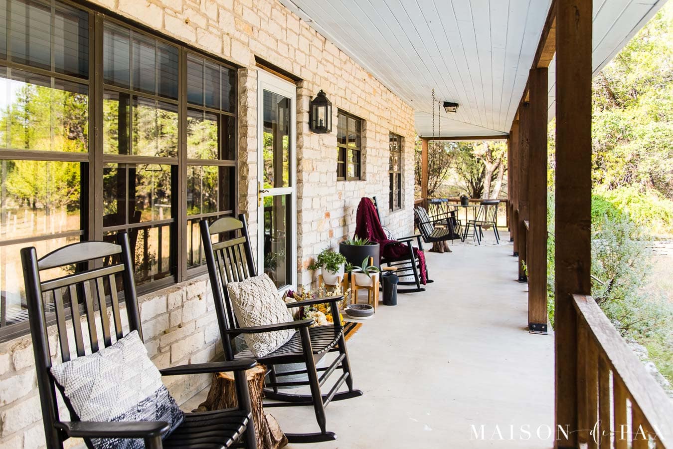 black rocking chairs on long covered porch | Maison de Pax