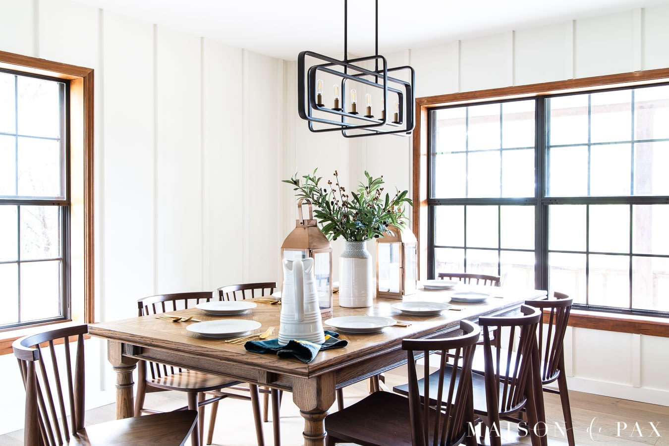 white farmhouse dining room with wood table and board and batten walls | Maison de Pax