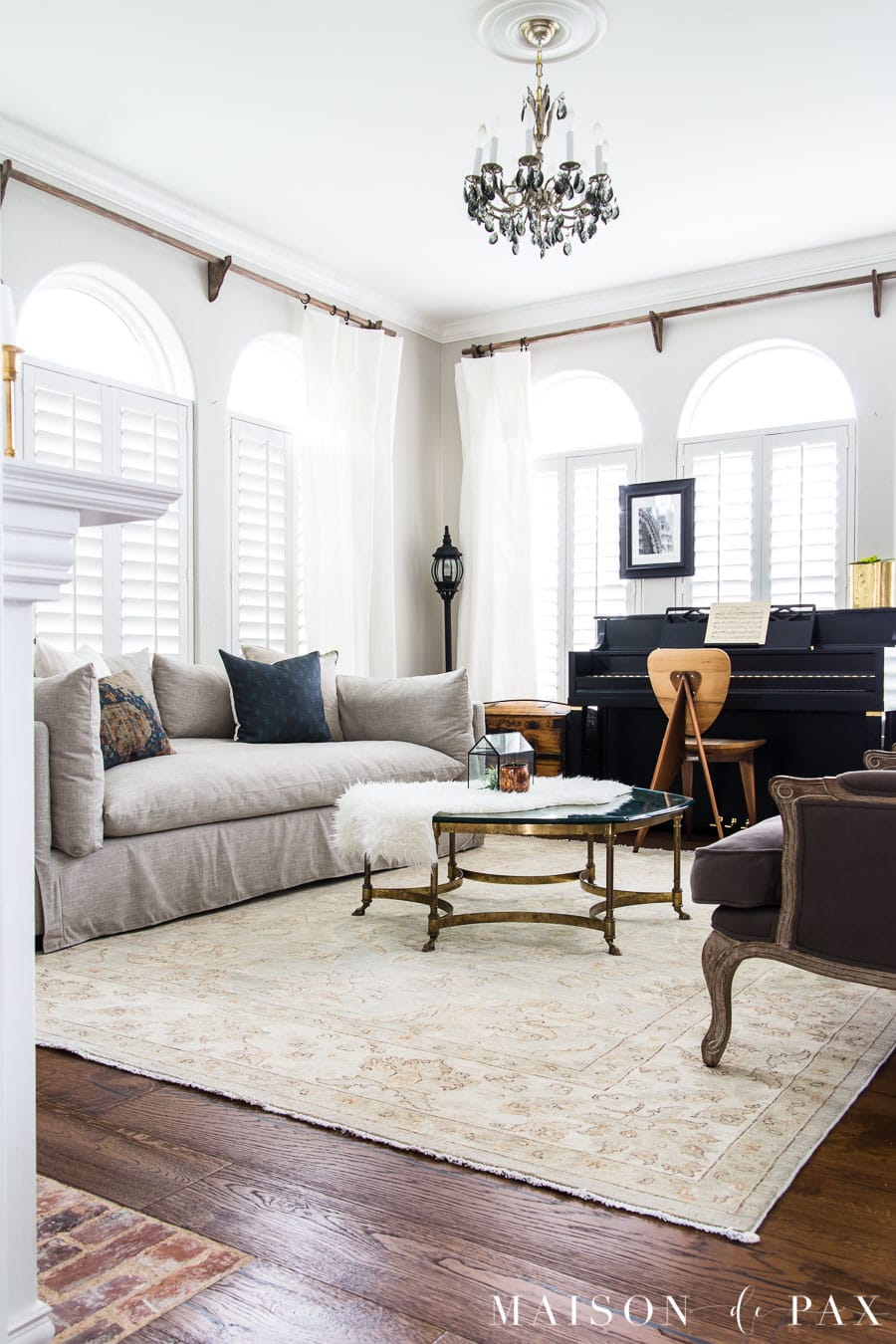 elegant neutral living room with black upright piano | Maison de Pax