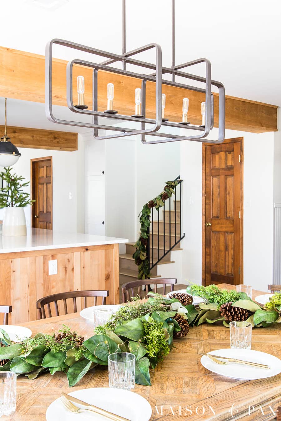 wood beams white walls magnolia garland in dining room | maison de Pax