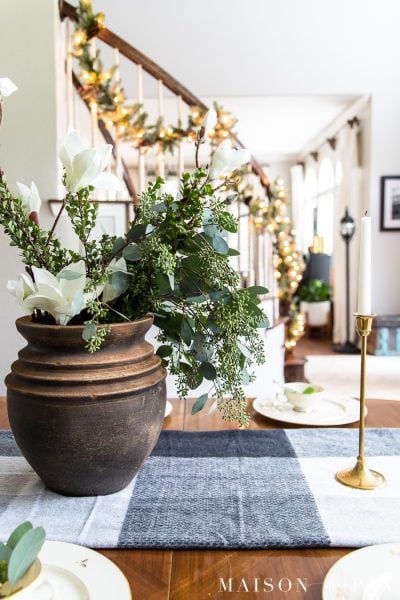 black pot with greenery and brass candlesticks holiday centerpiece | maison de pax