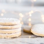 stacked iced cookies with sugar sprinkled on top and christmas lights | maison de pax