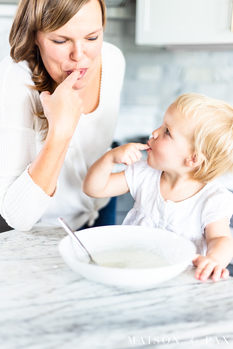 woman and child tasting icing | Maison de Pax