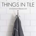 turkish towel hanging on chrome towel hook on wall of white subway tile | Maison de Pax