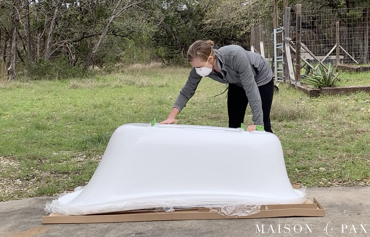 sanding the outside of a clawfoot tub for painting | Maison de Pax