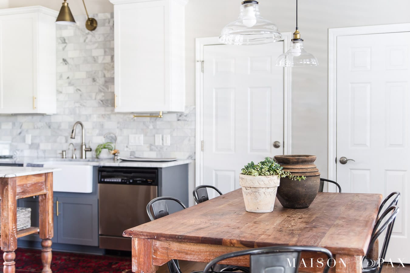 gray and white marble kitchen with wood island and table | Maison de Pax