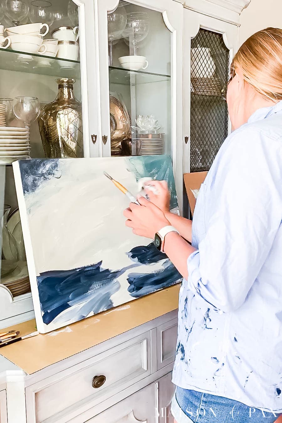woman blotting acrylic paint from canvas | Maison de Pax