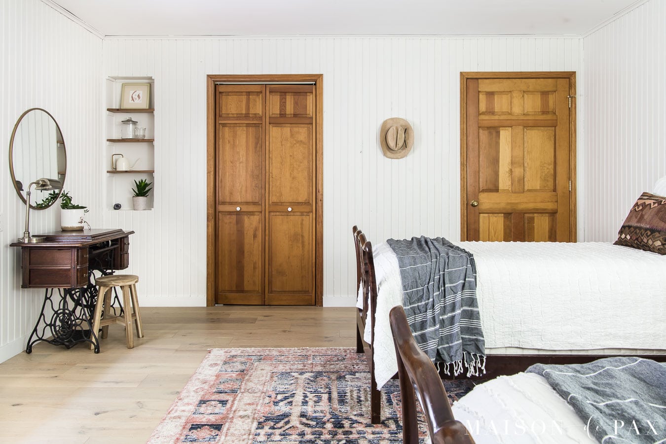 white planked walls with wood doors in white farmhouse bedroom | Maison de Pax