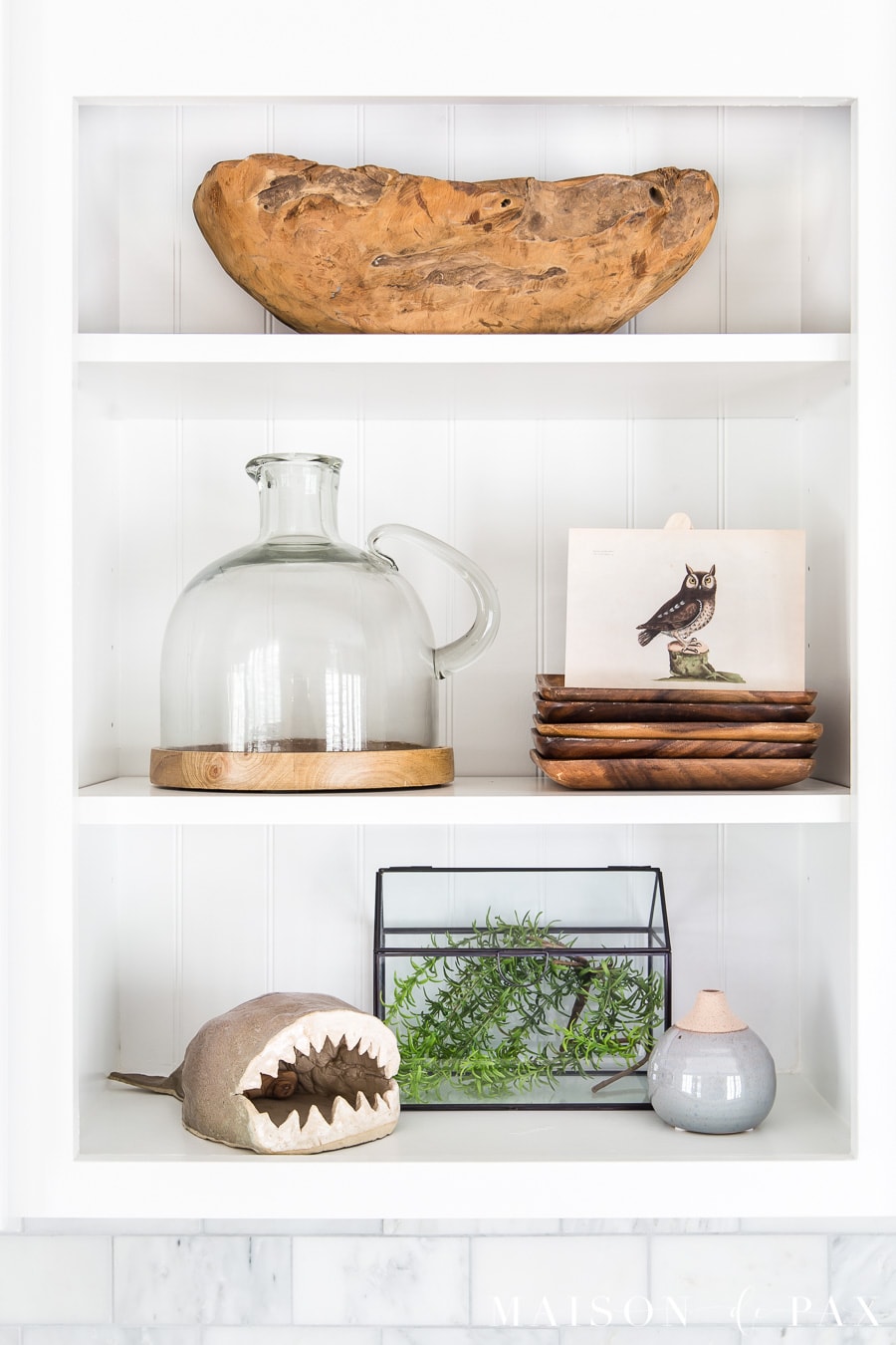 shelves styled with natural wood tones, greenery, and vintage art | Maison de Pax