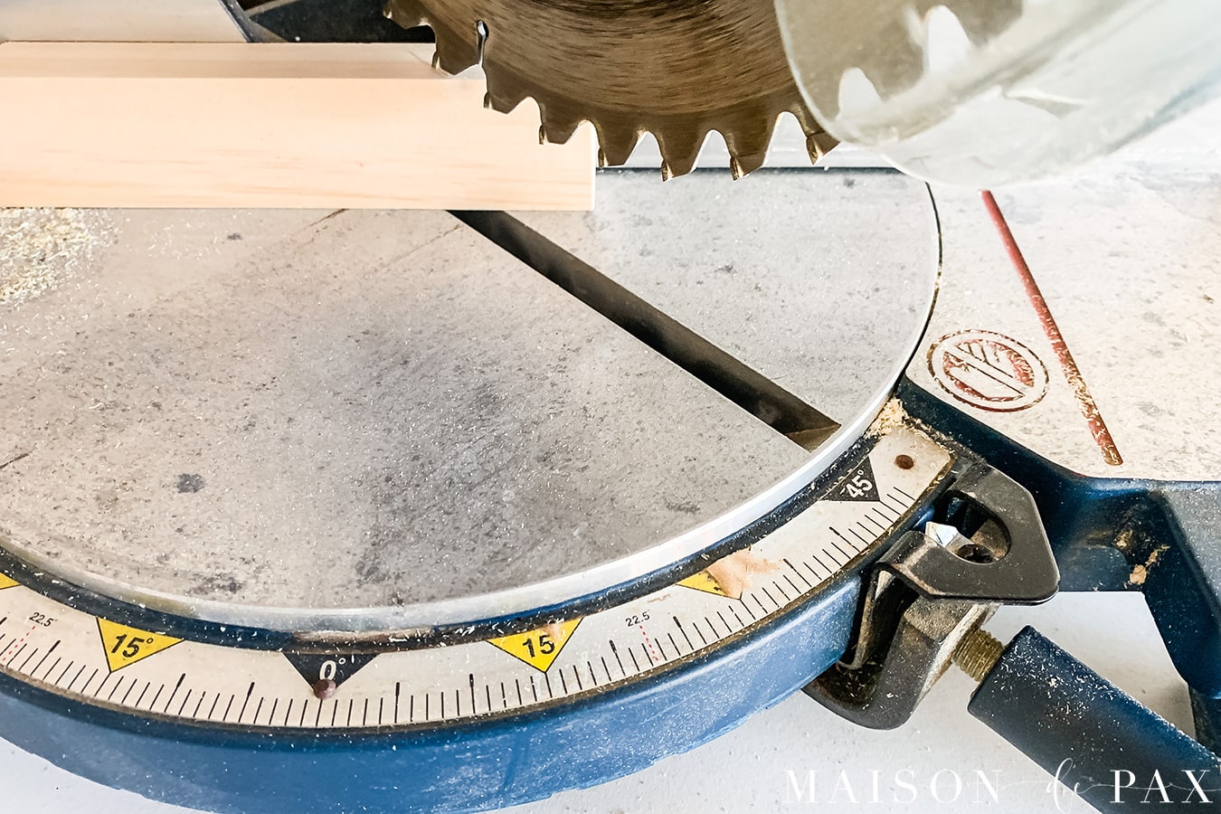 using a chop saw to cut a 45 degree angle for a wood picture frame | Maison de Pax