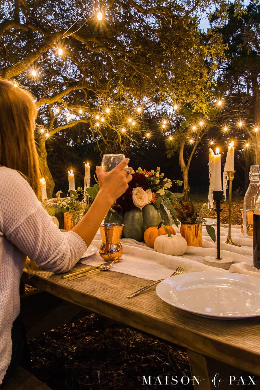 string lights over picnic table set for friendsgiving | Maison de Pax
