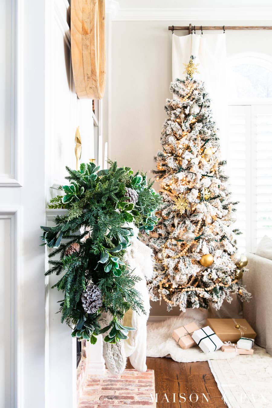 lush green mantel garland with simple flocked Christmas tree | Maison de Pax