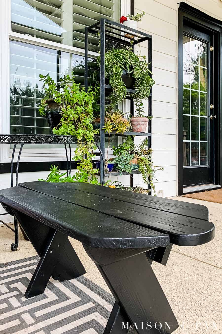 black painted bench on patio