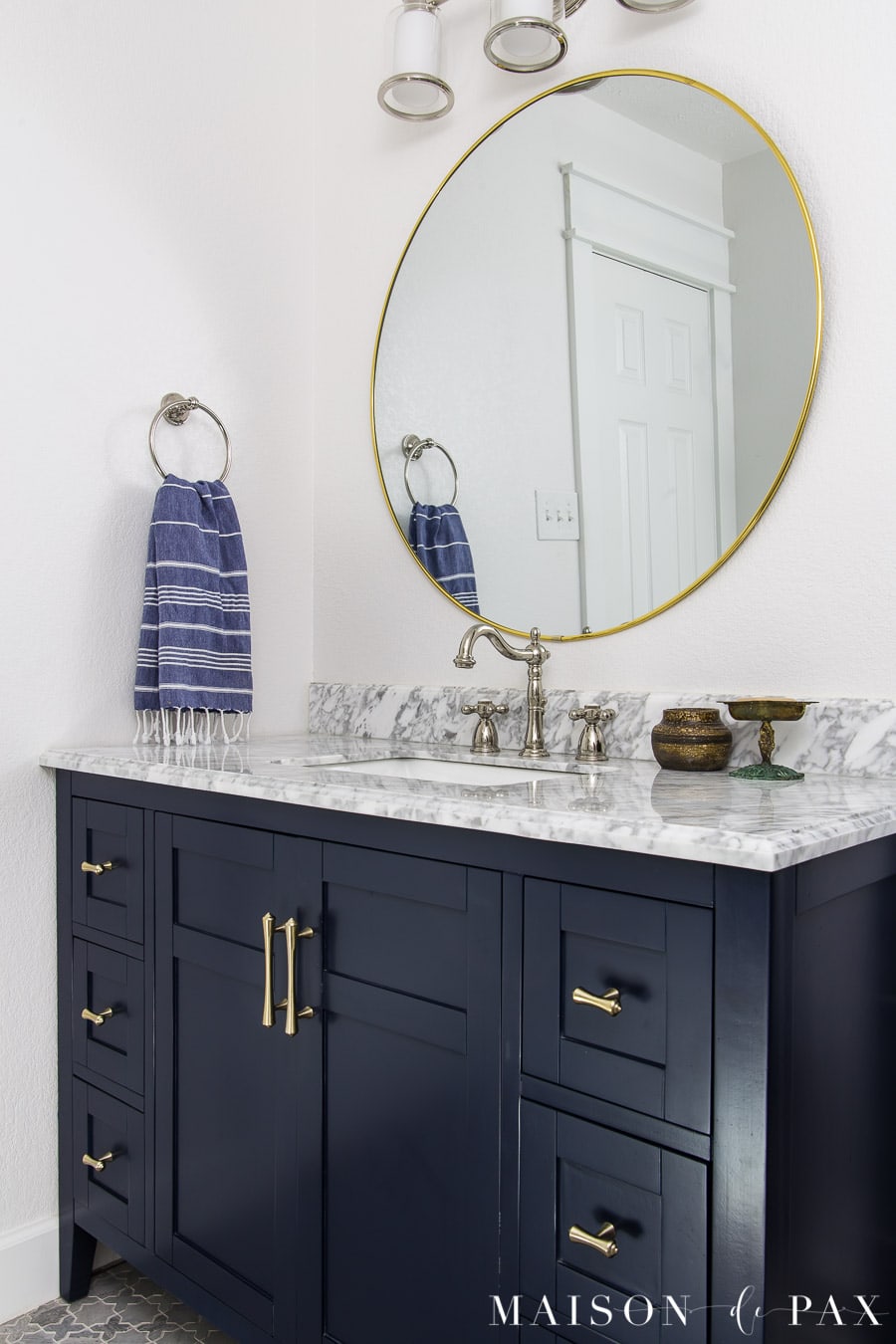 blue and white bathroom with navy vanity