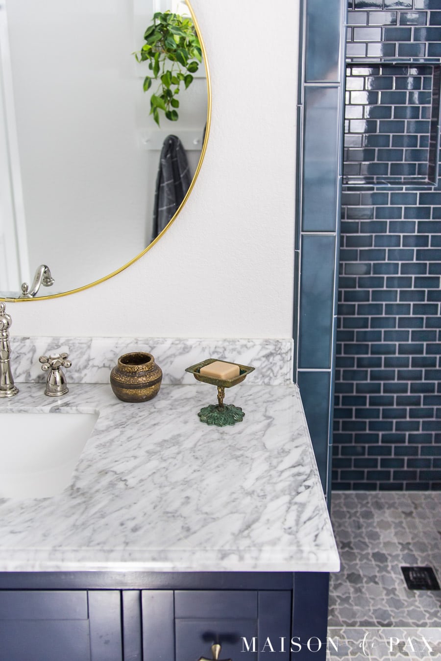 marble countertop with peacock blue shower tile