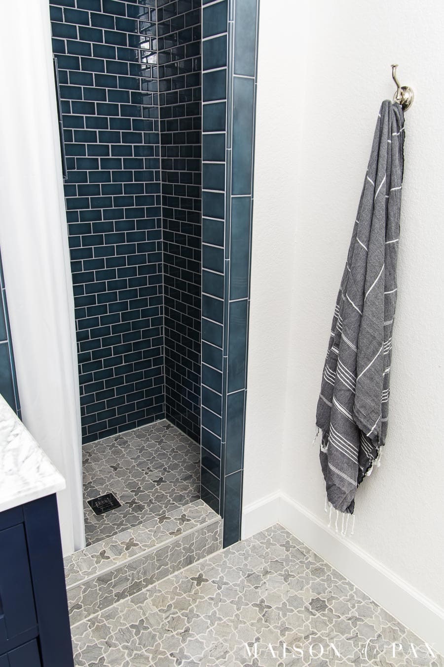 gray marble mosaic tile floor in blue and white bathroom