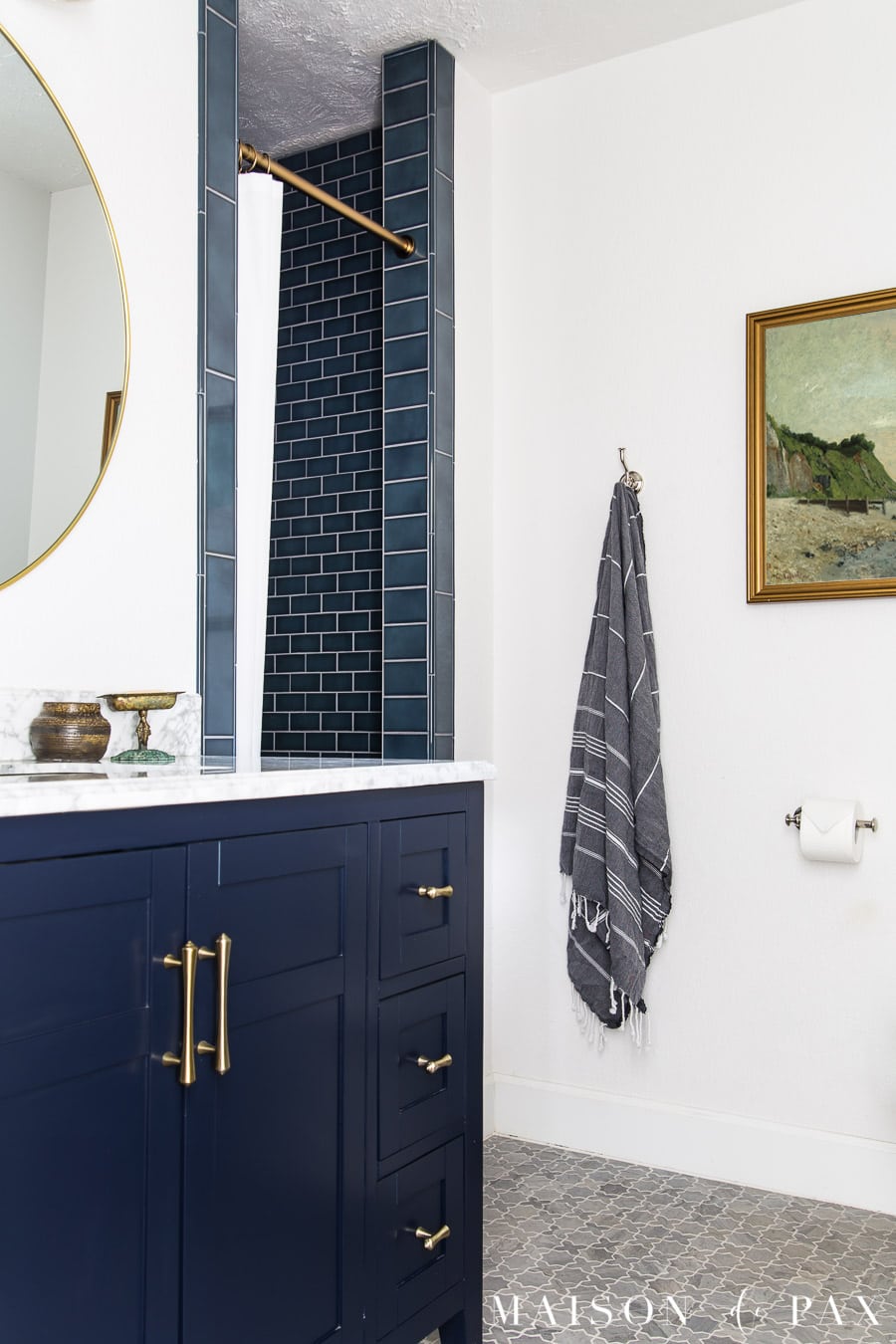 blue and white bathroom with vintage art