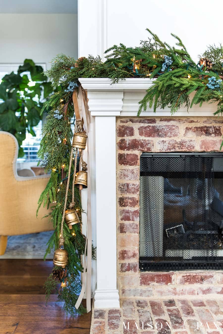 essential holiday decor items: brass bells and velvet ribbon on holiday coat