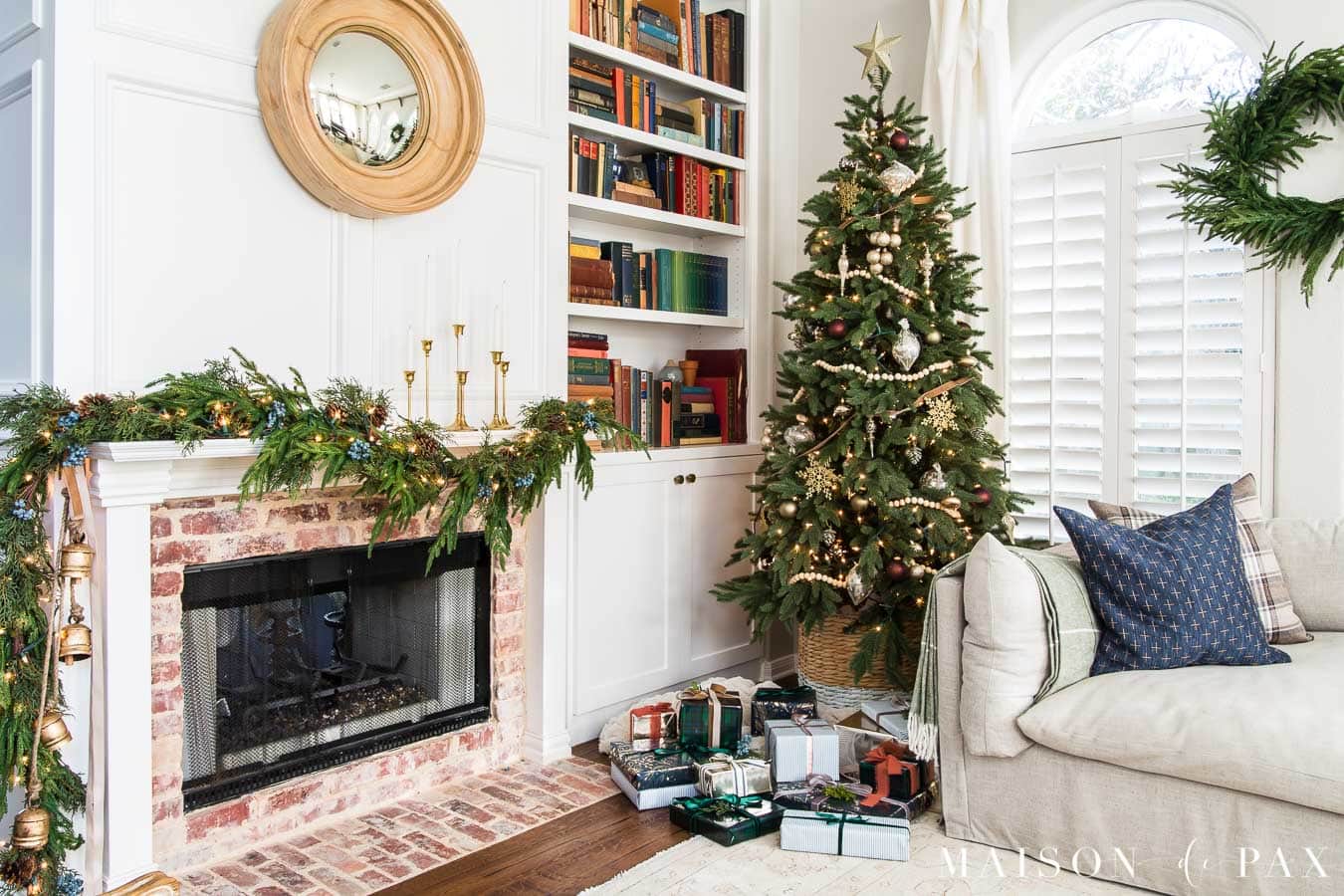 Christmas tree and fireplace with asymmetrical greenery trailing garland