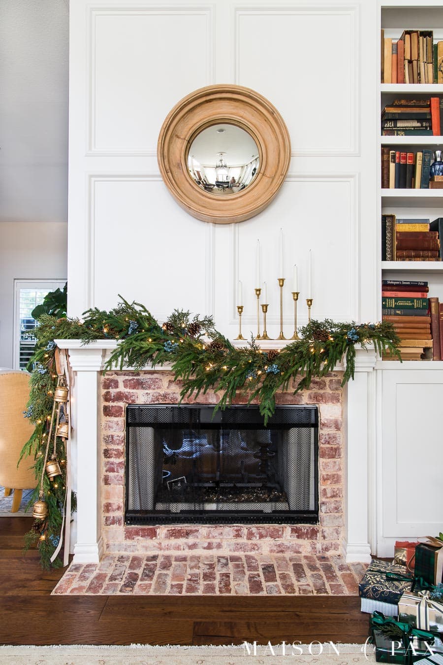 Christmas fireplace with asymmetrical garland hanging from the mantel